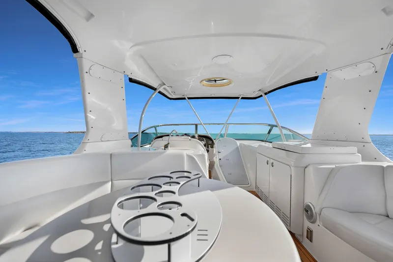Slide: The Image of Luxurious 2005 Carver 560 Voyager yacht interior with ocean view and sleek white seating. - 26