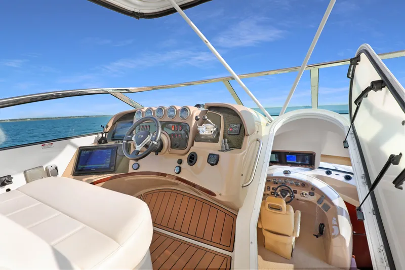 Slide: The Image of Interior view of 2005 Carver 560 Voyager yacht helm with modern controls and ocean backdrop. - 34
