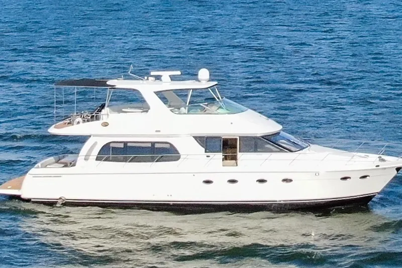 Slide: The Image of 2005 Carver 560 Voyager yacht cruising on open water. - 4