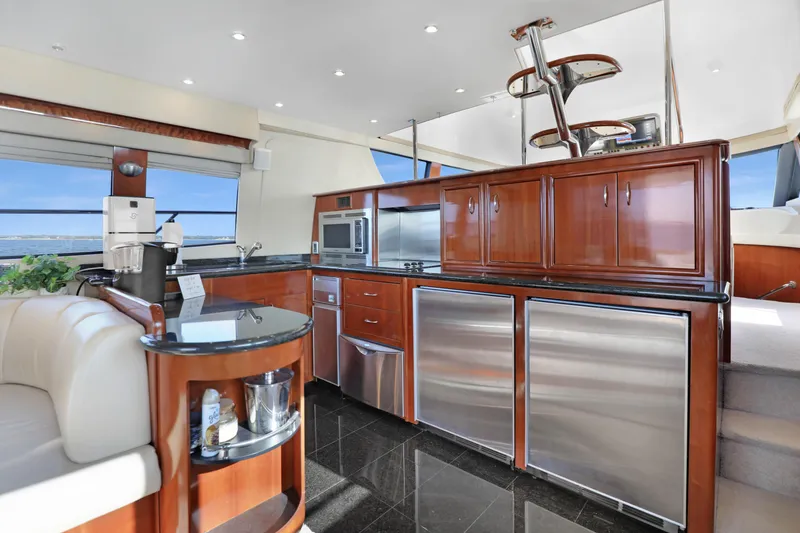 Slide: The Image of Luxurious 2005 Carver 560 Voyager yacht interior with modern kitchen and elegant wood cabinetry. - 45