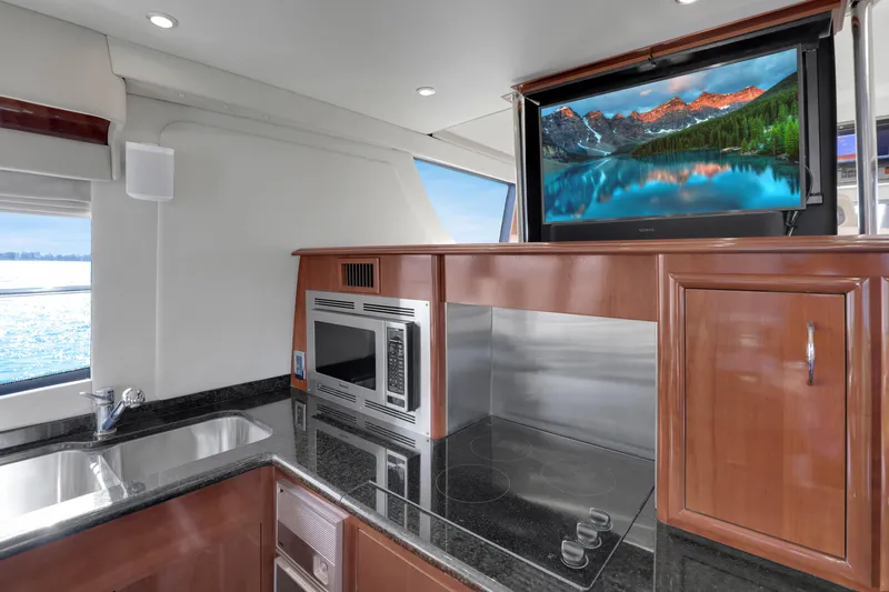 Slide: The Image of Luxurious 2005 Carver 560 Voyager yacht kitchen with modern appliances and scenic view. - 49