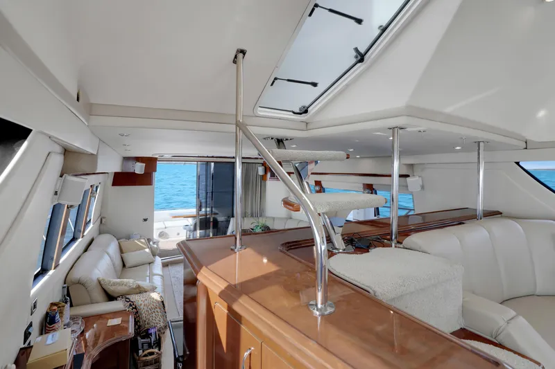 Slide: The Image of Luxurious interior of 2005 Carver 560 Voyager yacht with elegant seating and staircase. - 51