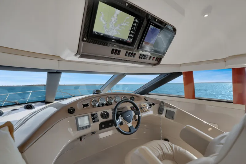 Slide: The Image of Interior helm of 2005 Carver 560 Voyager yacht with navigation screens and ocean view. - 55