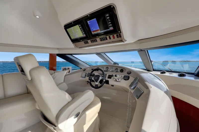Slide: The Image of 2005 Carver 560 Voyager yacht helm with modern navigation displays and luxurious seating. - 56