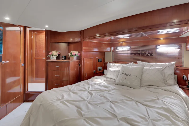 Slide: The Image of Luxurious 2005 Carver 560 Voyager yacht bedroom with elegant wood finish and plush bedding. - 61