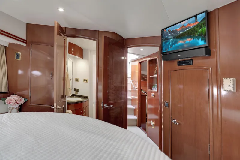 Slide: The Image of Luxurious interior of 2005 Carver 560 Voyager yacht with wood finishes and mounted TV. - 68