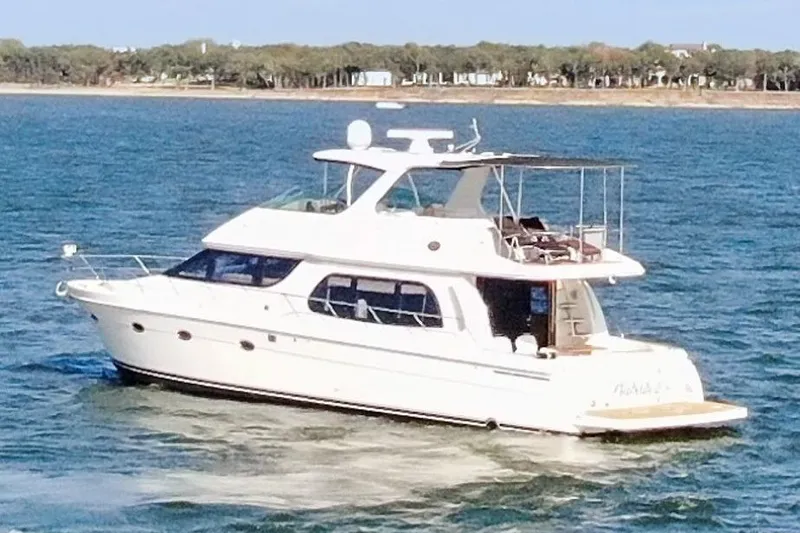 Slide: The Image of 2005 Carver 560 Voyager yacht cruising on open water. - 7