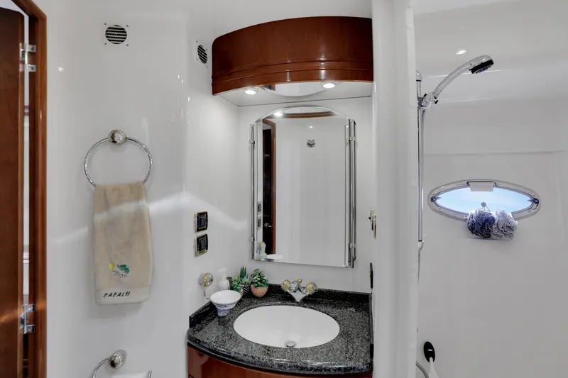 Slide: The Image of Luxurious bathroom in 2005 Carver 560 Voyager yacht with elegant fixtures and porthole window. - 70