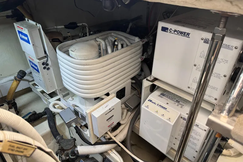 Slide: The Image of Engine room of 2005 Carver 560 Voyager with marine equipment and transformers. - 74