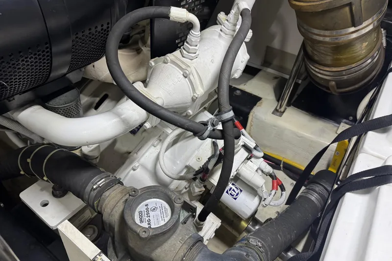 Slide: The Image of Engine compartment of a 2005 Carver 560 Voyager yacht, showcasing mechanical components. - 77