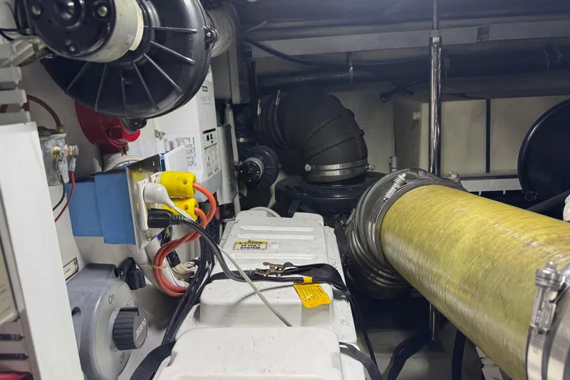 Slide: The Image of Engine room of a 2005 Carver 560 Voyager yacht, featuring electrical and mechanical components. - 79