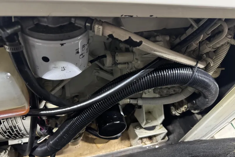 Slide: The Image of Engine compartment of a 2005 Carver 560 Voyager with visible hoses and components. - 82