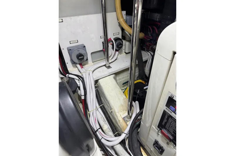 Slide: The Image of Engine room of 2005 Carver 560 Voyager with wiring and control panels. - 86