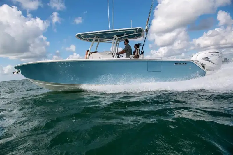 Slide: The Image of 2025 Jupiter 34 boat cruising on open water under a clear blue sky. - 10