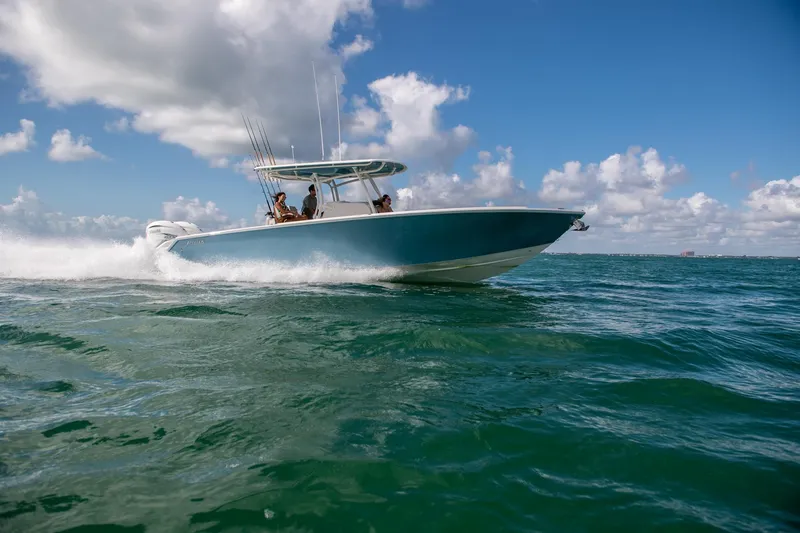 Slide: The Image of 2025 Jupiter 34 boat cruising on open water under a clear blue sky. - 11
