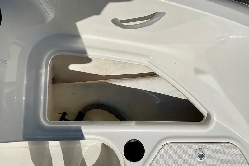 Slide: The Image of Storage compartment on a 2016 Bayliner Element boat, featuring sleek white interior design. - 11