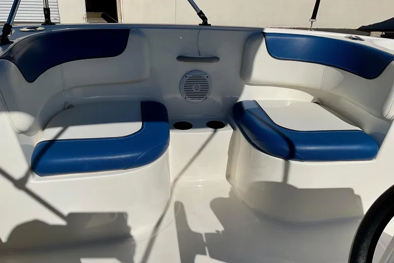 Slide: The Image of 2016 Bayliner Element boat interior with blue and white seating. - 13