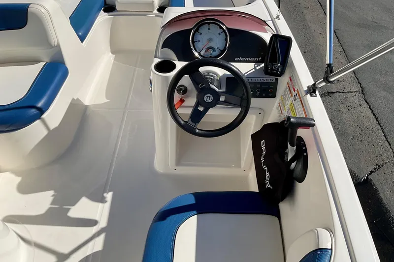Slide: The Image of 2016 Bayliner Element boat interior with steering wheel and blue seating. - 14