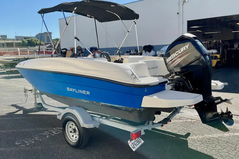 Slide: The Image of 2016 Bayliner Element boat with Mercury engine on trailer, parked outdoors. - 5
