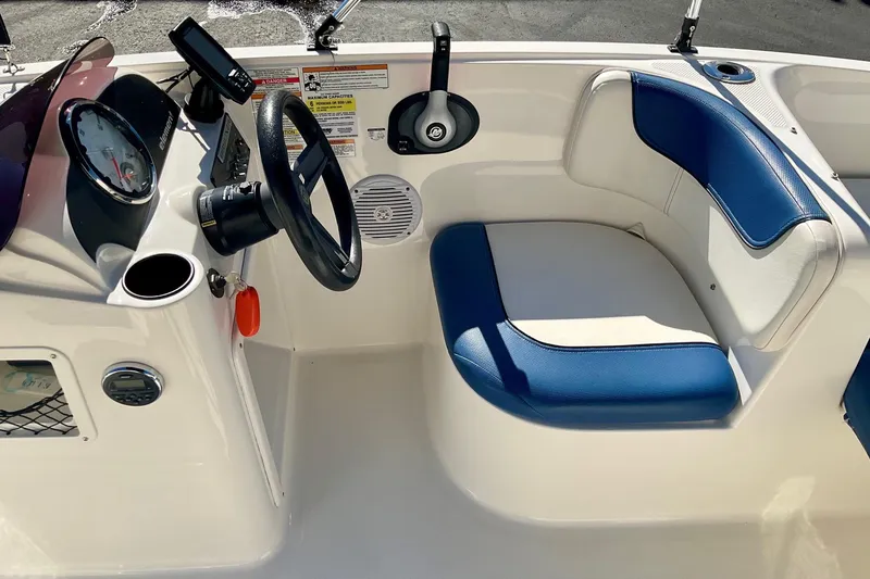 Slide: The Image of 2016 Bayliner Element boat interior with steering wheel and blue seating. - 9