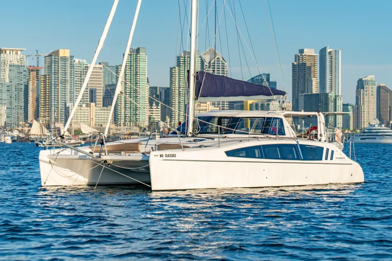 The Image of 2023 Seawind 1160 Lite catamaran sailing near a city skyline. - 0