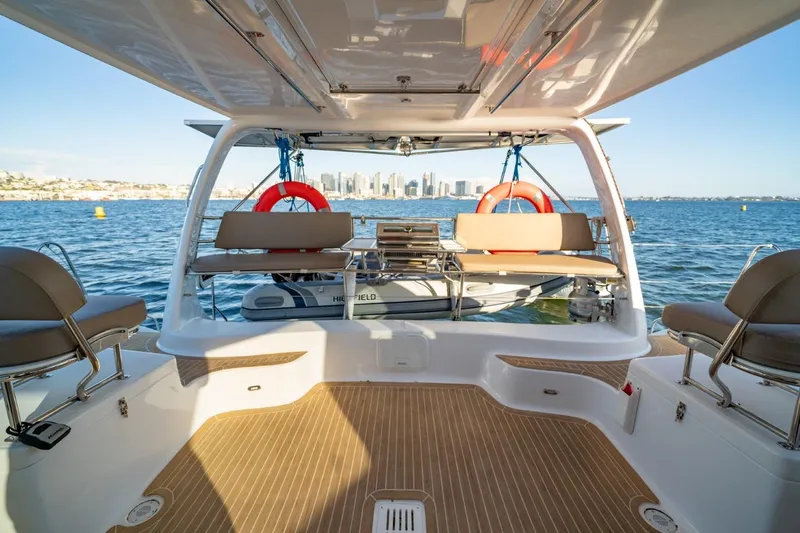 Slide: The Image of 2023 Seawind 1160 Lite catamaran interior with ocean view and city skyline. - 12