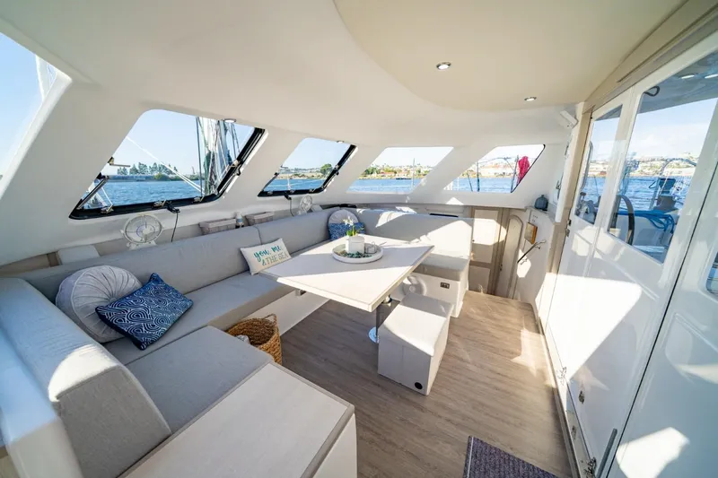 Slide: The Image of Spacious interior of 2023 Seawind 1160 Lite catamaran with modern seating and panoramic windows. - 13