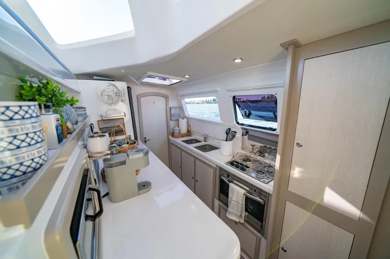 Slide: The Image of Modern kitchen interior of 2023 Seawind 1160 Lite catamaran, featuring sleek design and ocean view. - 17