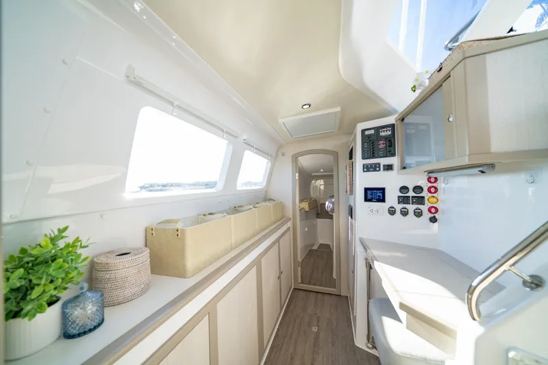 Slide: The Image of Interior of 2023 Seawind 1160 Lite catamaran, featuring modern design and control panel. - 19