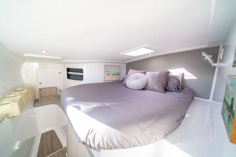 Slide: The Image of Cozy bedroom in 2023 Seawind 1160 Lite catamaran with skylight and modern decor. - 21