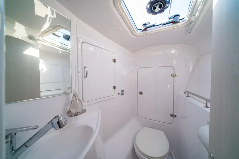 Slide: The Image of 2023 Seawind 1160 Lite yacht bathroom with skylight, sink, and toilet. - 26