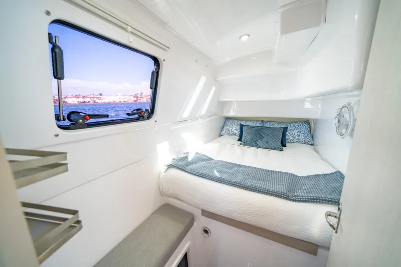 Slide: The Image of Cozy cabin interior of 2023 Seawind 1160 Lite catamaran with ocean view window. - 27