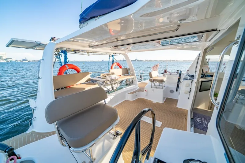 Slide: The Image of 2023 Seawind 1160 Lite catamaran interior with seating, ocean view, and modern design. - 9