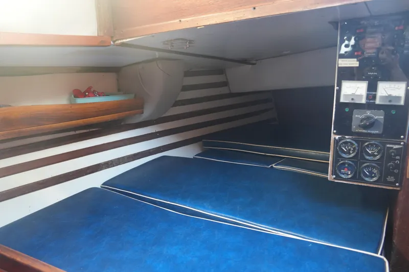 Slide: The Image of Interior cabin of 1979 Endeavour 37 sailboat with blue cushions and control panel. - 25