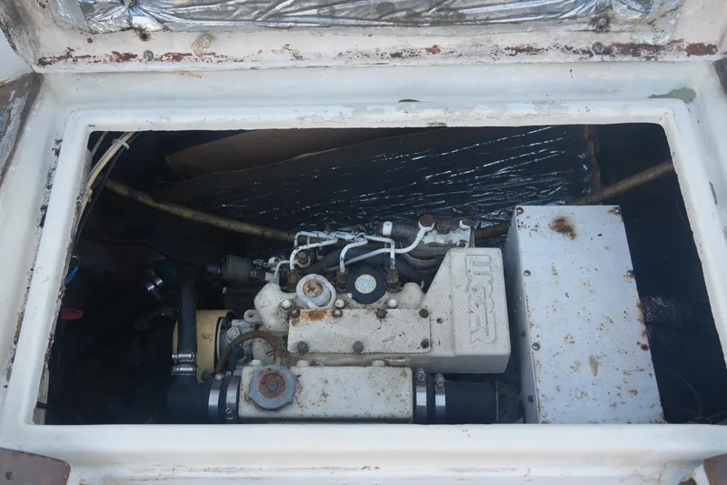 Slide: The Image of Engine compartment of a 1979 Endeavour 37 sailboat, showing mechanical components. - 28
