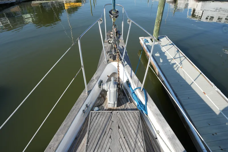 Slide: The Image of Bow of 1979 Endeavour 37 sailboat docked at marina, featuring anchor and deck details. - 3