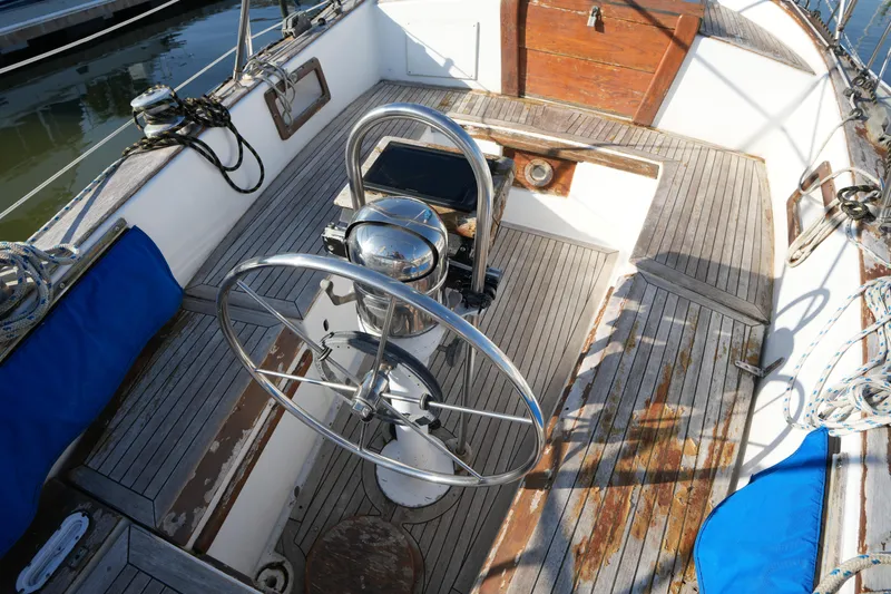 Slide: The Image of Cockpit of 1979 Endeavour 37 sailboat with wooden deck and steering wheel. - 7