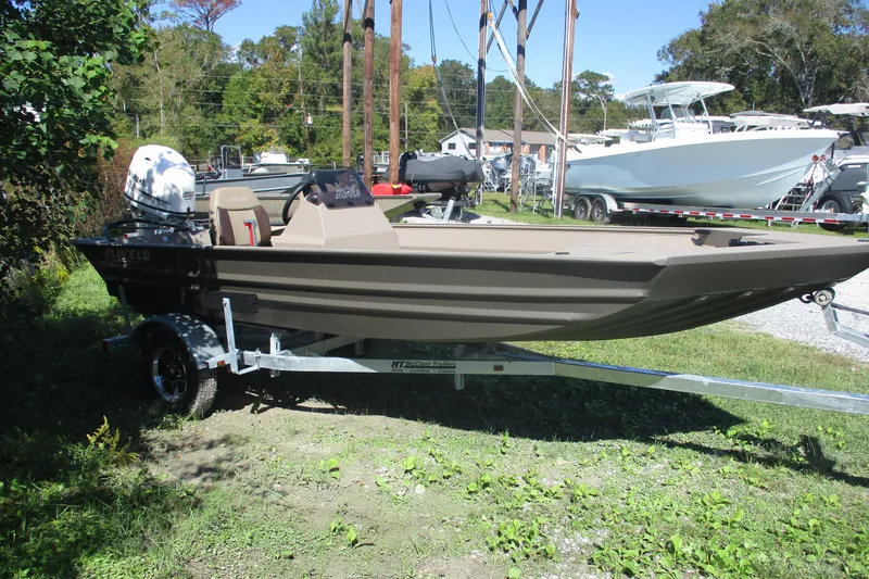 Slide: The Image of 2025 Alweld 1652 Marsh boat on trailer, parked outdoors in a grassy area. - 3