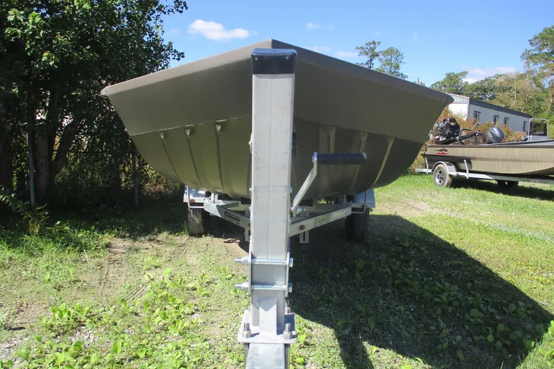 Slide: The Image of 2025 Alweld 1652 Marsh boat on trailer, parked on grassy area under clear sky. - 5