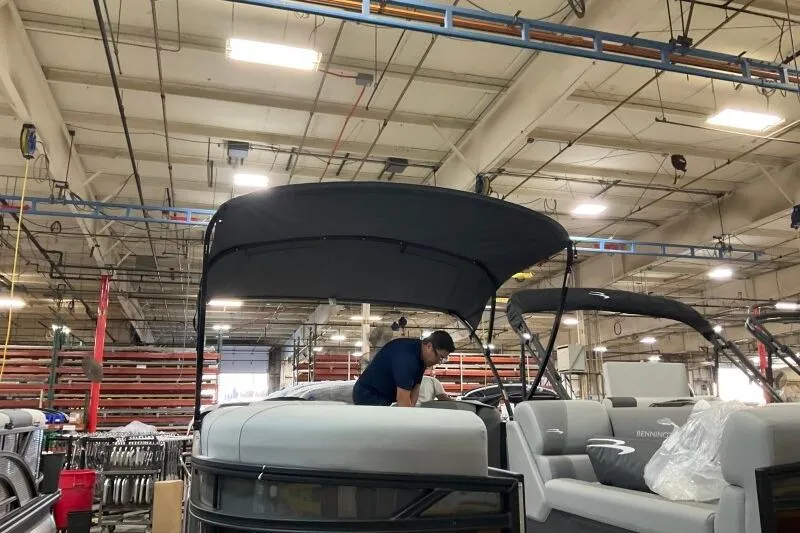Slide: The Image of 2026 Bennington 22 SSRSE pontoon boat assembly in factory setting. - 10