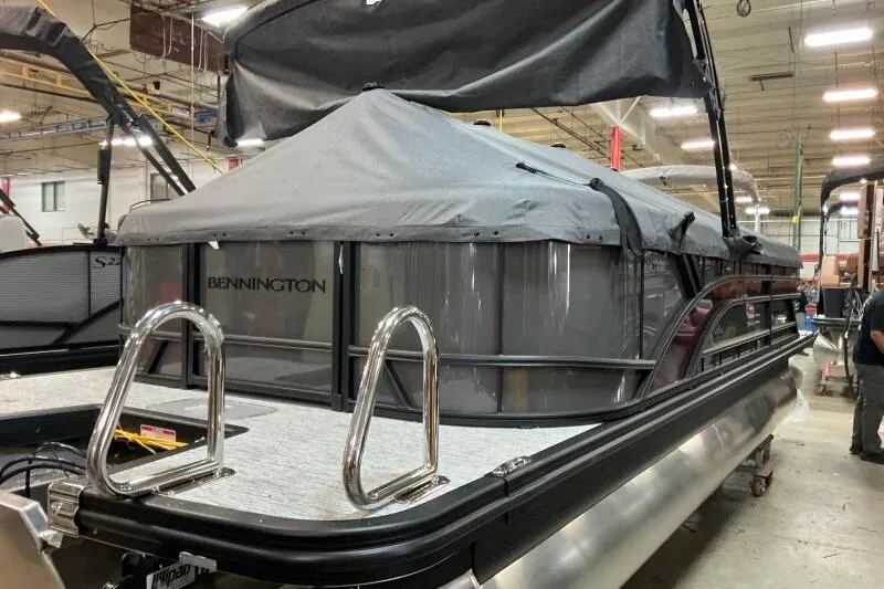 Slide: The Image of 2026 Bennington 22 SSRSE pontoon boat with cover in a showroom. - 14