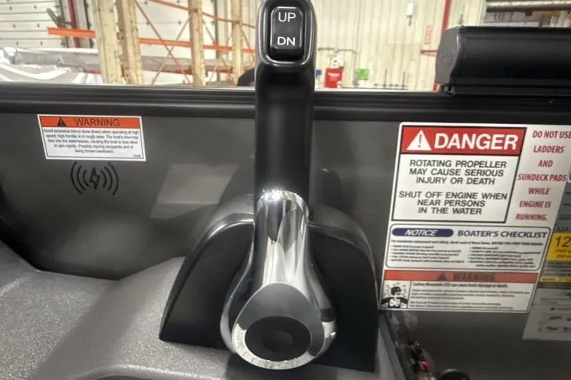 Slide: The Image of Control panel of 2026 Bennington 22 SSRSE boat with safety warnings and lever. - 23