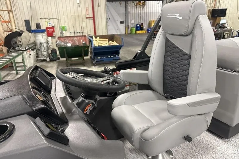 Slide: The Image of 2026 Bennington 22 SSRSE boat interior with modern steering and comfortable seating. - 24