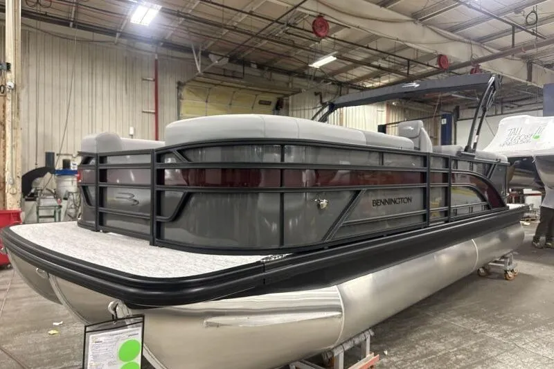 Slide: The Image of 2026 Bennington 22 SSRSE pontoon boat in a warehouse setting. - 6