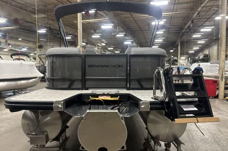 Slide: The Image of 2026 Bennington 22 SSRSE pontoon boat in a factory setting, rear view. - 7