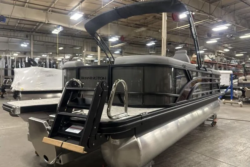 Slide: The Image of 2026 Bennington 22 SSRSE pontoon boat in a warehouse setting. - 8