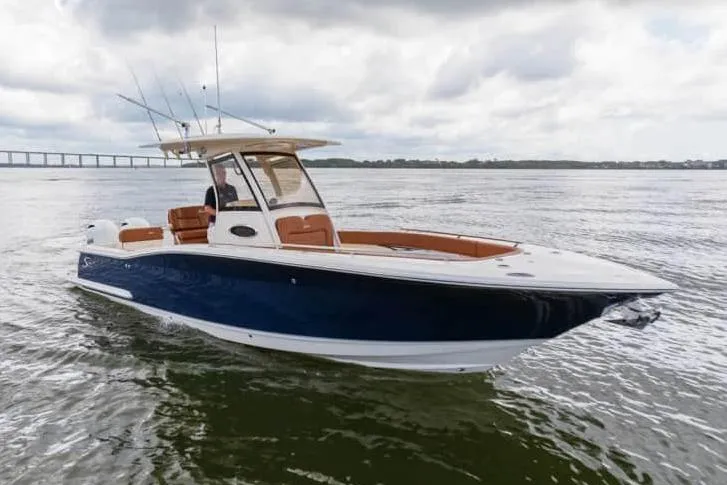 The Image of Manufacturer Provided Image: 2025 Scout 277 LXF boat on water, featuring sleek design and fishing rods. - 0