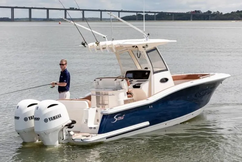 Slide: The Image of Manufacturer Provided Image: 2025 Scout 277 LXF boat with dual Yamaha engines on calm water. - 2