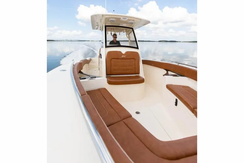 Slide: The Image of Manufacturer Provided Image: 2025 Scout 277 LXF boat cruising on calm water, featuring luxurious seating and sleek design. - 6