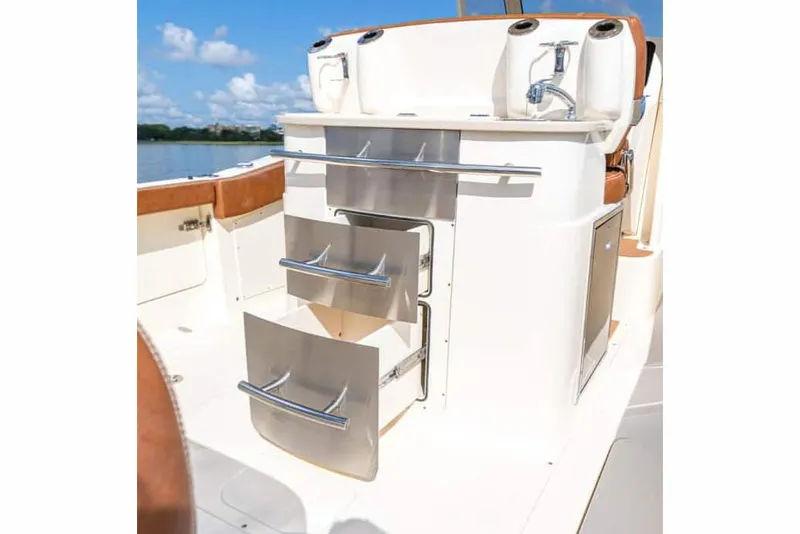 Slide: The Image of Manufacturer Provided Image: 2025 Scout 277 LXF boat interior with storage drawers and sink. - 9